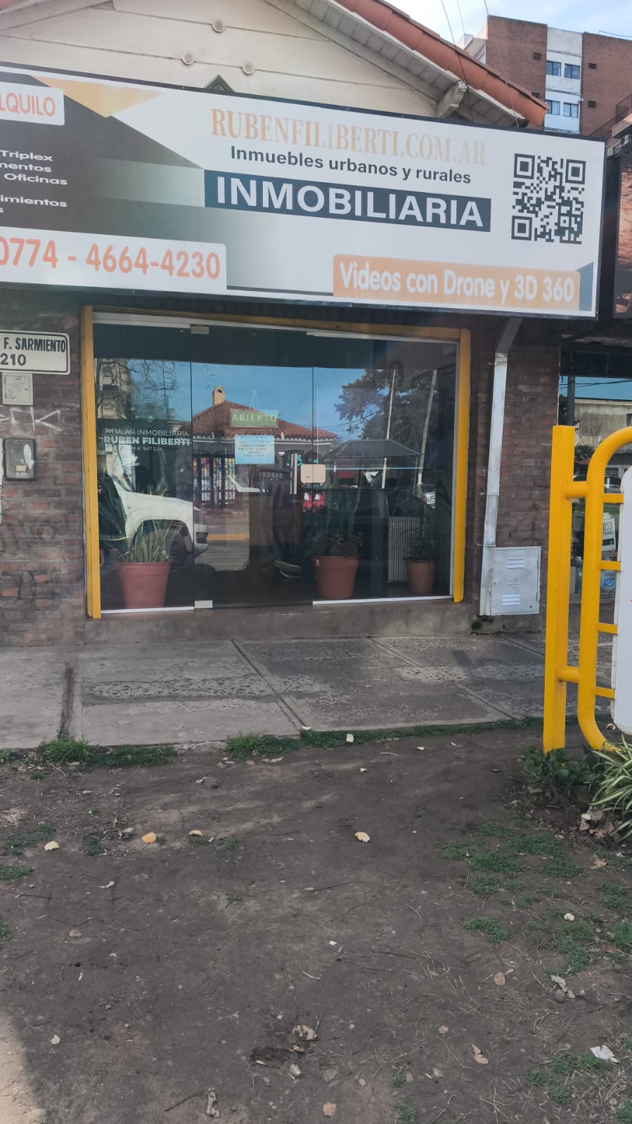 Fachada moderna del local Ruben Filiberti Propiedades con ventanales de doble altura en San Miguel
